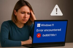 Windows 11 25H2 Update Fails with Error 0x800700c1? Here’s How to Fix It (KB5066835) 1 Windows 11 update shows error 0x800700c1 with a warning triangle and a Retry button; user looking puzzled, gears icon in the background.